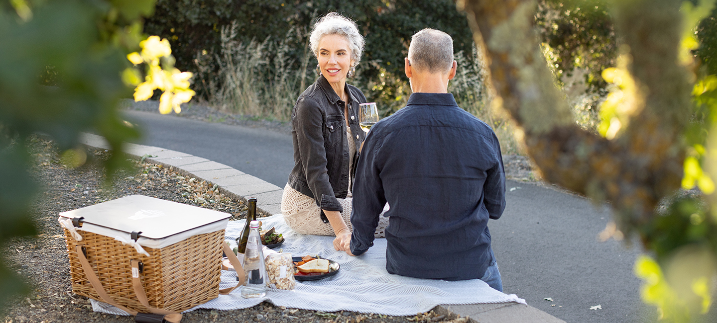 Couple on a picnic having white wine