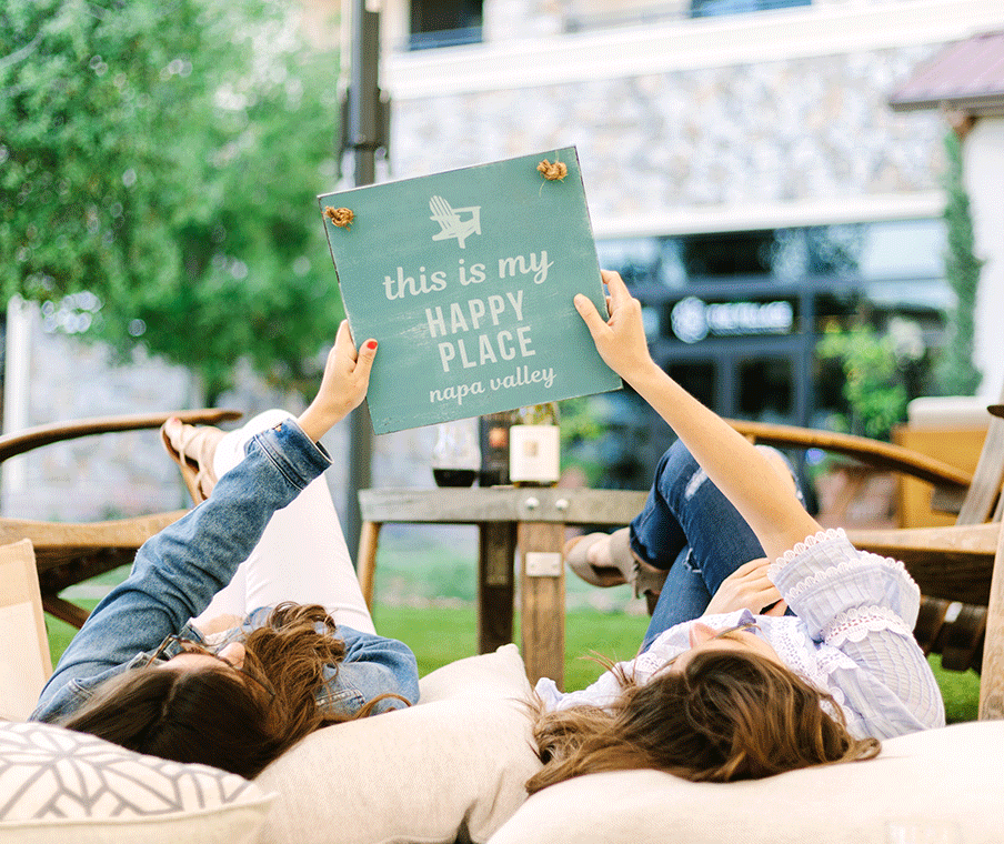 women holding sign in field
