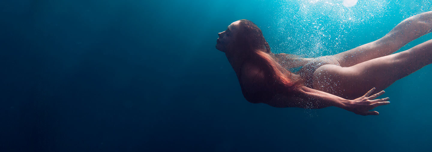 Woman Swimming In Ocean