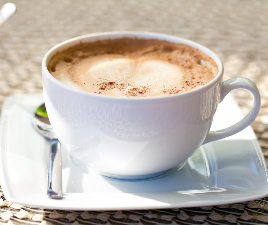 Coffee cup on plate with spoon
