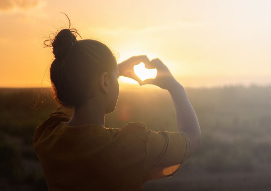 woman making a heart with her hands