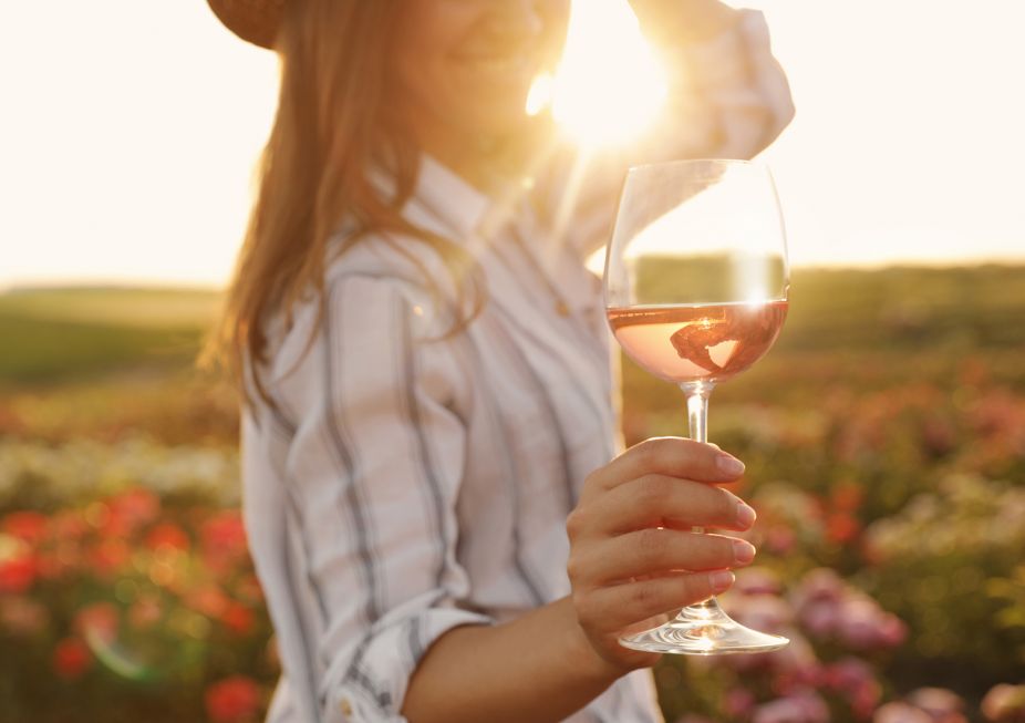 woman with wine in vineyard